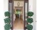 View from the front door into the home, showcasing the beautiful hardwood floors and stylish decor at 25813 Feather Ridge Ln, Sorrento, FL 32776