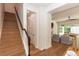 Bright entryway featuring stairs with hardwood floors, and a living room with natural light at 25813 Feather Ridge Ln, Sorrento, FL 32776