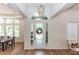 Elegant foyer with a decorative glass door, hardwood floors, and trim and wainscotting at 25813 Feather Ridge Ln, Sorrento, FL 32776