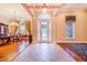 Grand foyer with tile flooring, decorative columns, and a view into the formal dining area at 25813 Feather Ridge Ln, Sorrento, FL 32776