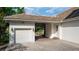 View of the attached garage and porte-cochere showing the paver driveway at 25813 Feather Ridge Ln, Sorrento, FL 32776