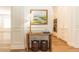 Hallway featuring hardwood floors and a decorative table with a lamp, connecting the living spaces at 25813 Feather Ridge Ln, Sorrento, FL 32776