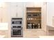 Detailed view of the kitchen, showcasing built-in appliances and cabinet storage and shelving at 25813 Feather Ridge Ln, Sorrento, FL 32776