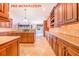 Gourmet kitchen with a large island, custom cabinets, and a seamless flow to the living area at 25813 Feather Ridge Ln, Sorrento, FL 32776