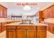 Large kitchen island with cooktop and granite countertops, perfect for entertaining at 25813 Feather Ridge Ln, Sorrento, FL 32776