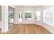 Light-filled living area with hardwood floors, large windows, and a door leading to the outdoor space at 25813 Feather Ridge Ln, Sorrento, FL 32776