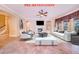 Inviting living room with a fireplace, tile floors, and ample seating at 25813 Feather Ridge Ln, Sorrento, FL 32776