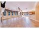 Spacious living room with tile floors, large windows, elegant draperies, and adjacent breakfast bar at 25813 Feather Ridge Ln, Sorrento, FL 32776