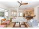 Cozy living room with elegant furnishings and an open layout connecting to the kitchen at 25813 Feather Ridge Ln, Sorrento, FL 32776