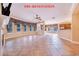 Expansive living room featuring tile floors, multiple windows, and a ceiling fan, before renovation at 25813 Feather Ridge Ln, Sorrento, FL 32776