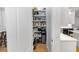 Walk-in pantry with custom shelving offers generous storage and easy organization at 25813 Feather Ridge Ln, Sorrento, FL 32776