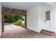 Porte cochere with brick pavers leading to a door and an arched stone entryway at 25813 Feather Ridge Ln, Sorrento, FL 32776