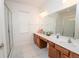 Bright bathroom featuring double vanity, modern fixtures, and glass enclosed shower at 2659 Calistoga Ave, Kissimmee, FL 34741