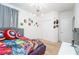 Bedroom featuring superhero themed decorations, carpet flooring, and a closet with standard bi-fold doors at 2659 Calistoga Ave, Kissimmee, FL 34741