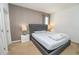 Bedroom features a tufted headboard, neutral colored walls, side tables with lamps, and carpet flooring at 2659 Calistoga Ave, Kissimmee, FL 34741