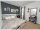 Bedroom featuring black and gray accent wall with artwork, a large mirror, desk, and carpet flooring at 2659 Calistoga Ave, Kissimmee, FL 34741