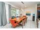 Modern dining room with a wooden table, seating for eight, and a sliding glass door leading to the pool at 2659 Calistoga Ave, Kissimmee, FL 34741