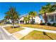 Inviting two-story home with a well-maintained lawn and lush palm trees lining the street at 2659 Calistoga Ave, Kissimmee, FL 34741