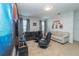 Fun game room with decorative wall art, comfortable seating, and entertainment setup at 2659 Calistoga Ave, Kissimmee, FL 34741
