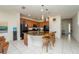 Bright kitchen with granite countertops, a large island with seating, and an adjacent dining area at 2659 Calistoga Ave, Kissimmee, FL 34741