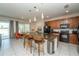 Modern kitchen with granite countertops, a large island with seating, and stylish pendant lighting at 2659 Calistoga Ave, Kissimmee, FL 34741