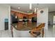 Open kitchen featuring granite countertops, a large island with barstools, and modern black appliances at 2659 Calistoga Ave, Kissimmee, FL 34741