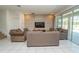 Comfortable living room featuring tile flooring, modern decor, and sliding glass doors to outdoor patio at 2659 Calistoga Ave, Kissimmee, FL 34741