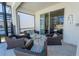 Covered patio seating area with wicker furniture, glass table, and access to the pool area at 2659 Calistoga Ave, Kissimmee, FL 34741