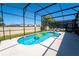 Pool with inflatable toys, and screened in enclosure featuring multiple lounge chairs at 2659 Calistoga Ave, Kissimmee, FL 34741
