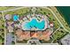 Aerial view of community pool area, clubhouse, playground, and lake with fountain at 2694 Giardino Loop, Kissimmee, FL 34741