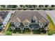 Aerial view of multiple modern townhomes with well-maintained landscaping and manicured lawns at 2694 Giardino Loop, Kissimmee, FL 34741