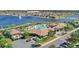 Aerial view of community pool area, clubhouse and lake with fountain feature at 2694 Giardino Loop, Kissimmee, FL 34741