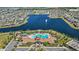 Aerial view of community pool area, clubhouse and lake with fountain feature at 2694 Giardino Loop, Kissimmee, FL 34741