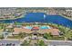 Aerial view of community pool area, clubhouse and lake with fountain feature at 2694 Giardino Loop, Kissimmee, FL 34741