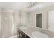 Bright bathroom featuring double sinks, shower, and vanity lighting at 2694 Giardino Loop, Kissimmee, FL 34741