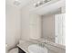 Neutral bathroom with a large mirror, bright lighting and a shower/tub combo at 2694 Giardino Loop, Kissimmee, FL 34741