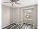 Neutral bedroom with large window and a ceiling fan at 2694 Giardino Loop, Kissimmee, FL 34741