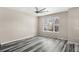Bright bedroom features updated flooring, a ceiling fan, and a large window at 2694 Giardino Loop, Kissimmee, FL 34741
