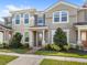 Inviting two-story townhome featuring a covered front porch and well-manicured landscaping at 2694 Giardino Loop, Kissimmee, FL 34741