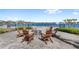 Outdoor seating around a fire pit, offering serene waterfront views for relaxation and socializing at 2694 Giardino Loop, Kissimmee, FL 34741