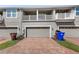 Townhome garages with brick paver driveways and second story patios at 2694 Giardino Loop, Kissimmee, FL 34741