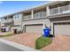 Townhome garages with brick paver driveways and second story patios at 2694 Giardino Loop, Kissimmee, FL 34741