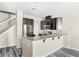Modern kitchen with stainless steel appliances, granite countertops, and a breakfast bar at 2694 Giardino Loop, Kissimmee, FL 34741