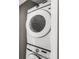 Stacked Samsung washer and dryer set in a laundry closet at 2694 Giardino Loop, Kissimmee, FL 34741