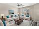 Comfortable living room featuring a large window with natural light and a stylish ceiling fan at 2694 Giardino Loop, Kissimmee, FL 34741