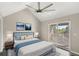 Bright main bedroom with a vaulted ceiling, ceiling fan and a private balcony at 2694 Giardino Loop, Kissimmee, FL 34741