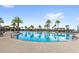 Community pool with clear blue water and many palm trees at 2694 Giardino Loop, Kissimmee, FL 34741