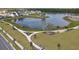 Breathtaking aerial view of the community lake, walking paths, and lush green spaces at 3002 Voyager Ave, St Cloud, FL 34771