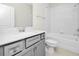 Well-lit bathroom features a white vanity, shower-tub combo and neutral color palette at 3002 Voyager Ave, St Cloud, FL 34771