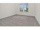Empty bedroom featuring neutral paint, carpeting, and a double window overlooking the front yard at 3002 Voyager Ave, St Cloud, FL 34771